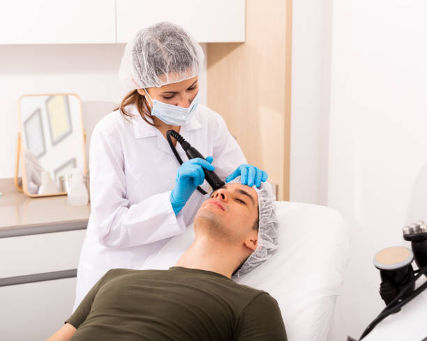 istock Man getting face ultrasound lifting procedure 1248420256
