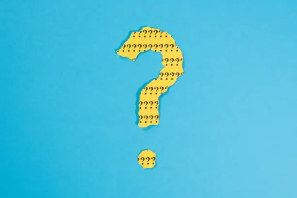 Photo of Question Mark From Teared Yellow Paper On Blue Background. Concept Of Faq