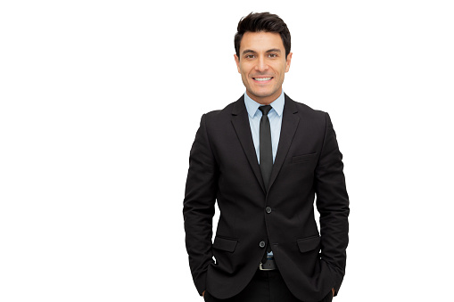 Confident businessman looking forward and being cool while standing on white studio background