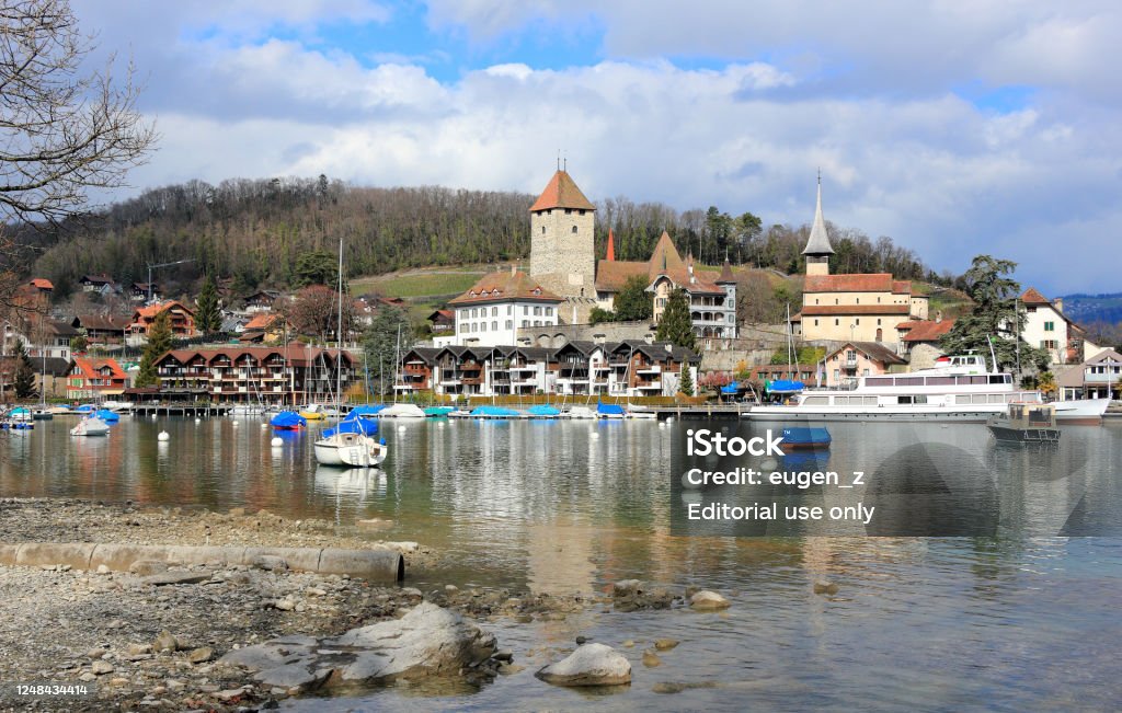 Spiez harbour, Spiez Castle and Lake Thun. Switzerland, Europe. Spiez, Switzerland - March 07, 2020: Visiting Spiez town on a sunny morning in March. Spiez is located on the southern shore of Lake Thun. Ancient Stock Photo