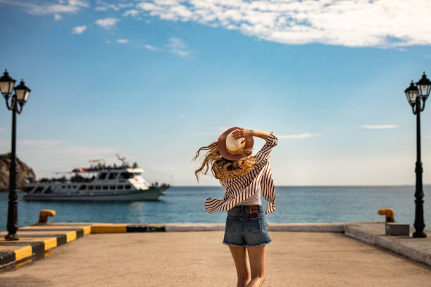 istock Young woman dancing by the sea 1248440945