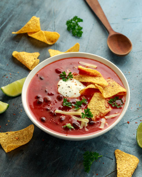 istock Mexican Chilli bean soup with yogurt, cheese, lime and tortilla chips in white bowl 1248441175