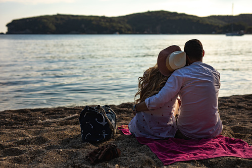 Couple enjoys sunset on the beach