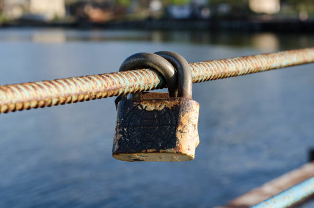 istock Old padlock. A padlock hangs on the railing. Rusty metal. 1248441240