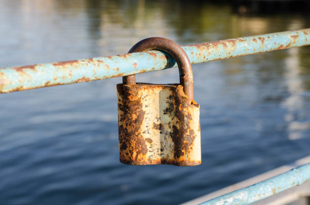 istock Old padlock. A padlock hangs on the railing. Rusty metal. 1248441258
