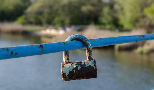 istock Old padlock. A padlock hangs on the railing. Rusty metal. 1248441279
