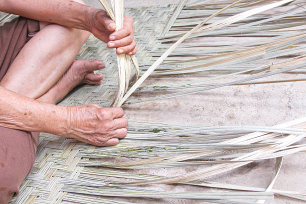 istock Weaving reed mat by old asian woman hand , handmade thai style 1248442893