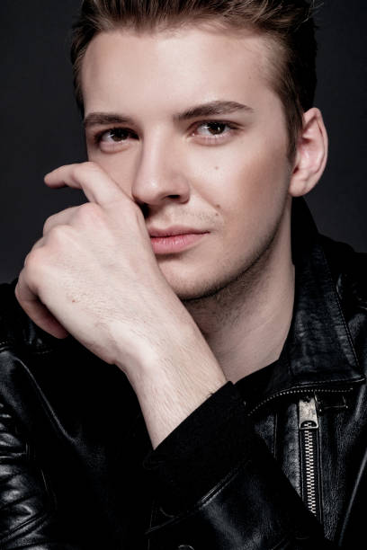 istock fashion model man in a black jacket on a gray background 1248443090
