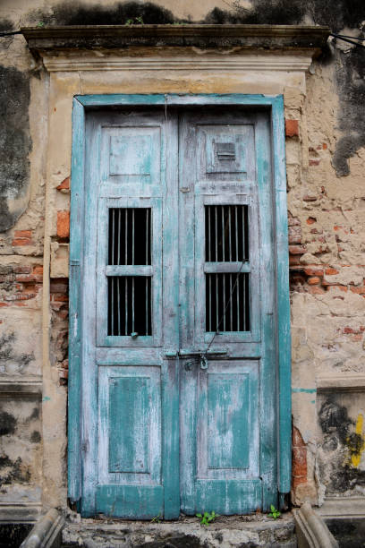 istock Old cracked wall with bule door ,Old brick wall. 1248443578
