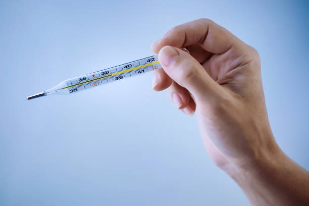 istock Thermometer in a woman\'s hand 1248445272