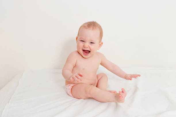istock laughing baby only in panties sits on bed 1248445977