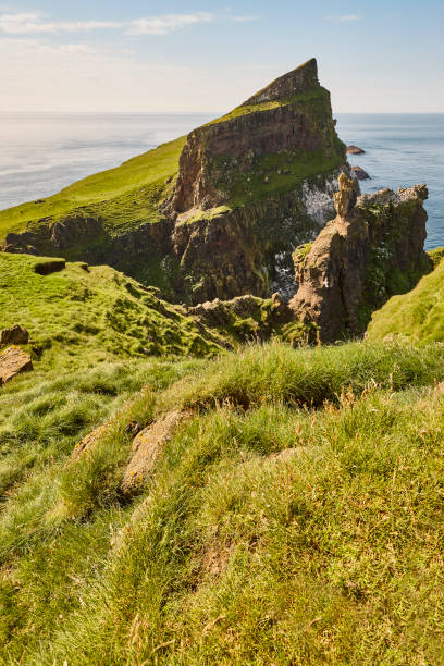 istock Mykines lighthouse and cliffs on Faroe islands. Hiking highlight. Denmark 1248449411
