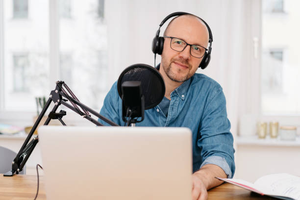 istock Man recording podcast looking at camera 1248449539