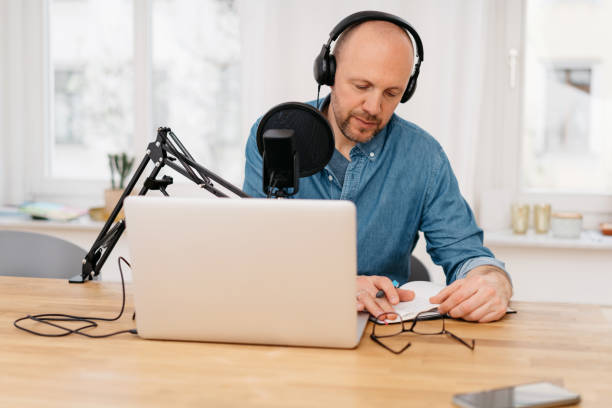 istock Middle-aged man working on recording a podcast 1248449542