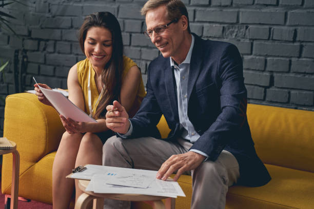istock Two delighted people working together at business plan 1248452576