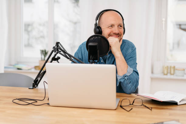 istock Man recording a podcast with a happy smile 1248452662