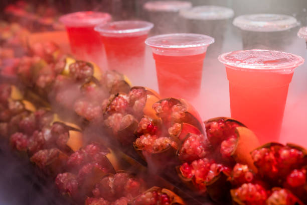 Chilled freshly squeezed pomegranate juice in a transparent plastic cup for sale on a stall in Muslim Quarter in Xian town, Shaanxi Province, central China