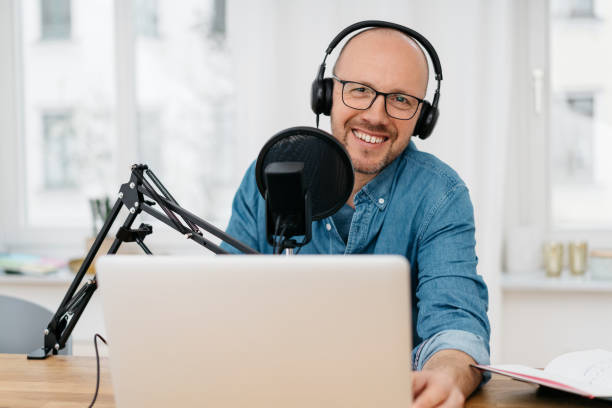 istock Happy friendly man recording a podcast 1248455636