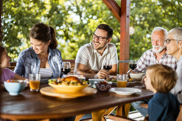 istock Happy multi-generation family talking during lunch on a terrace. 1248456185