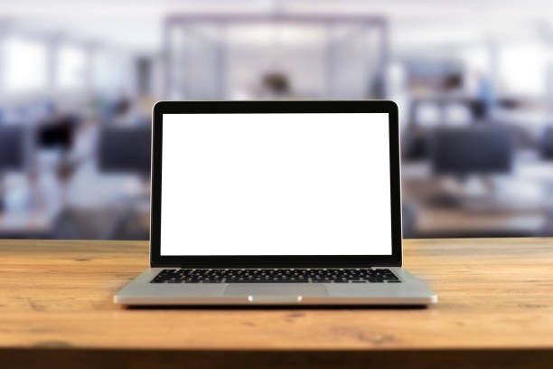 istock Mockup blank screen laptop on wood table in co-working space. 1248456712