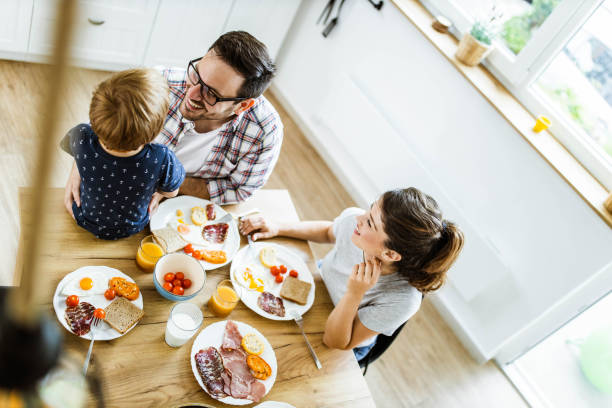 istock Above view of happy family having a breakfast at dining table. 1248456865