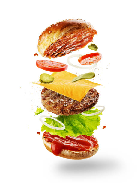 istock Burger with flying elements. Delicious hamburger with flying ingredients isolated on white background.  Food levitation concept 1248457262