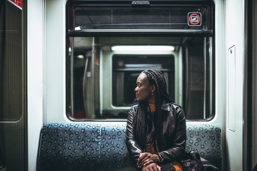 black woman sitting in the metro train