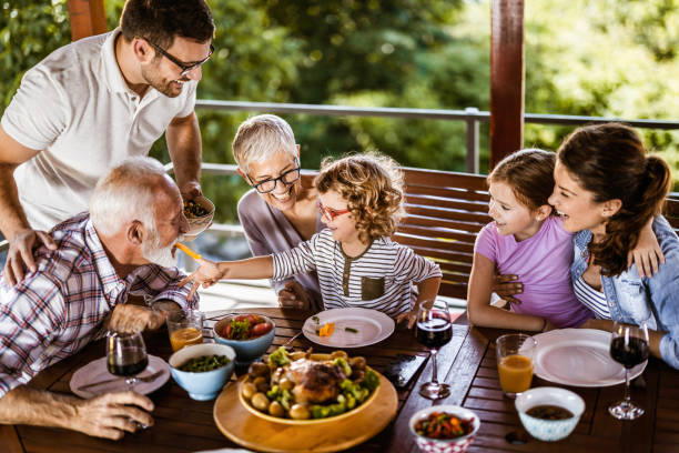 istock Happy multi-generation family talking while having lunch on a terrace. 1248460158