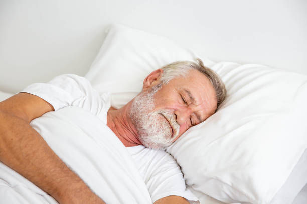 istock Worried senior retirement man lying awake in his bed 1248462151