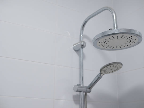 double shower heads with chrome finish in clean bathroom with pure white ceramic tiles. close-upimage with copy space double shower heads with chrome finish in clean bathroom with pure white ceramic tiles. close-upimage with copy space detachable stock pictures, royalty-free photos & images