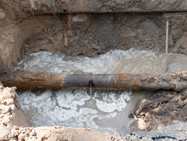 close-up of ruptured sewer rusty pipeline which cause sewage leakage stream and pollution. old infrastructure issues in the city construction site close-up of ruptured sewer rusty pipeline which cause sewage leakage stream and pollution. old infrastructure issues in the city construction site underground pipeline stock pictures, royalty-free photos & images