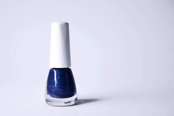 A bottle with blue nail polish on white background. nail lacquer. Nail manicure concept. Isolated, copy space.