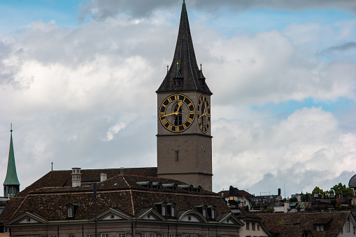 Old medieval church towers in Zurich city Switzerland summer day white clouds 2020