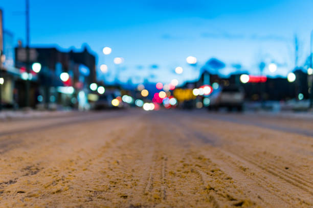 Blurry W 4th avenue in downtown, Anchorage, Alaska at dawn during winter.