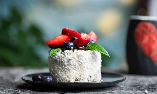 Coconut cake with chocolate and berry fruits on a plate