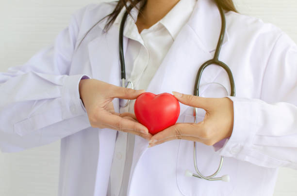 istock Female doctor with stethoscope holding heart 1248480607