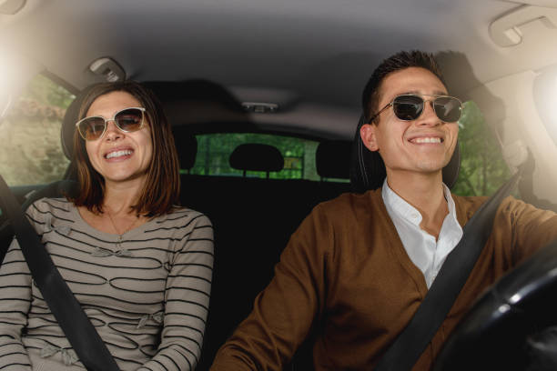 istock Young couple inside car fasten seat belts. 1248480811