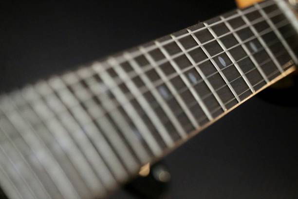 istock Guitar fret board on black background 1248482382