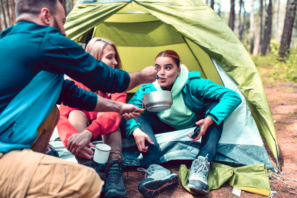 istock Camping Friends Eating Stew And Feeding Each Other 1248482445