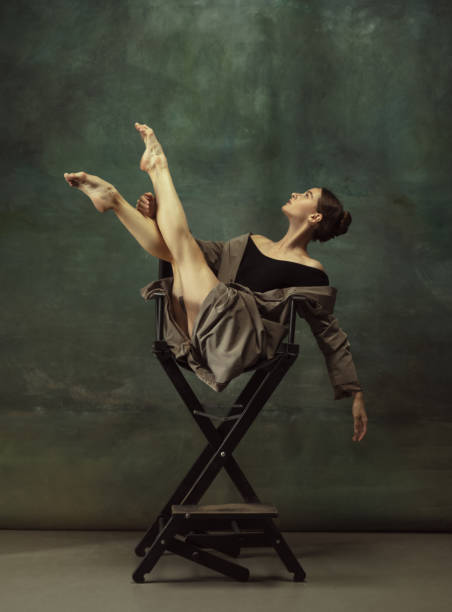 istock Young graceful tender ballerina on dark studio background 1248485824