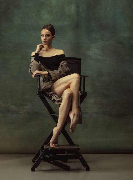 istock Young graceful tender ballerina on dark studio background 1248485829