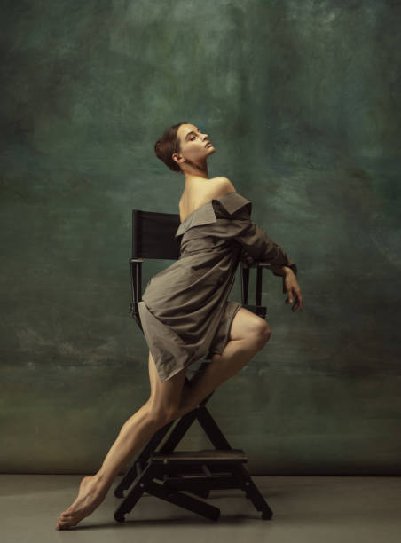 istock Young graceful tender ballerina on dark studio background 1248485832