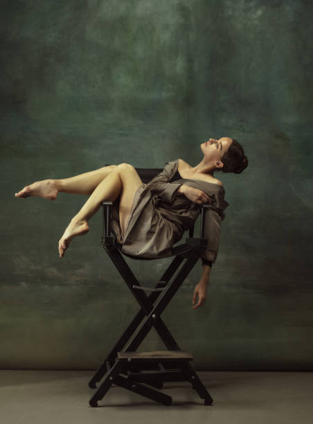 istock Young graceful tender ballerina on dark studio background 1248485833