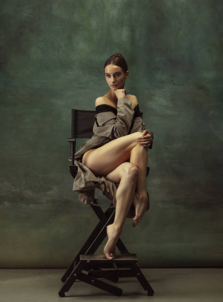 istock Young graceful tender ballerina on dark studio background 1248485841