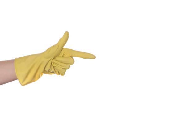 istock hand in a yellow glove for cleaning, index finger showing direction 1248486069