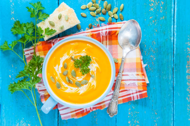 istock pumpkin cream soup on a table with ingredients, selective focus, top view, copy space 1248486269