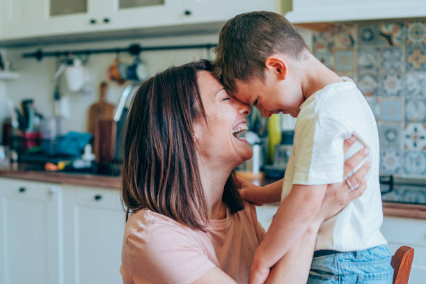 istock Affectionate mother and son embracing at home. 1248486368