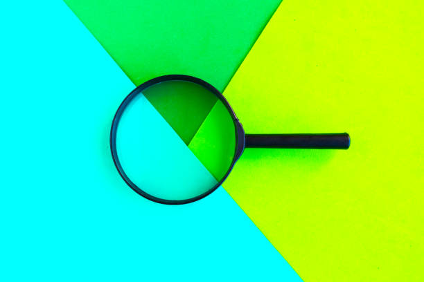 istock Magnifying glass on geometric green background. Minimal concept 1248486538