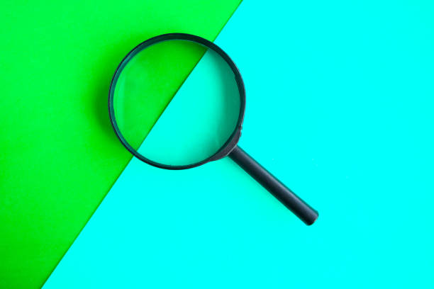 istock Magnifying glass on geometric green background. Minimal concept 1248486553