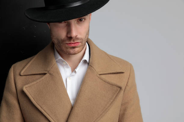 istock young fashion model in longcoat wearing hat 1248488122